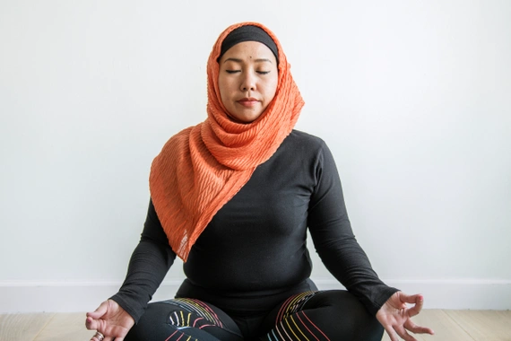 A woman practicing meditation in a calm environment