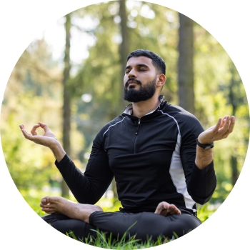Fit man in black sports wear, meditating in outdoors