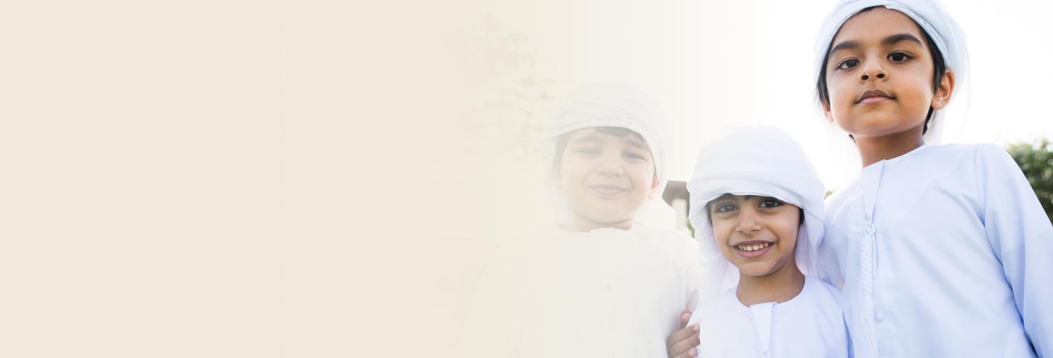 Kids in white thobe smiling with joy