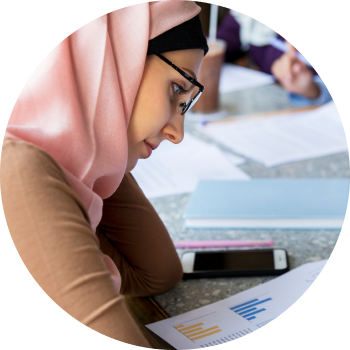 Student writing in a notebook, creating a focused environment for learning and self-confidence.