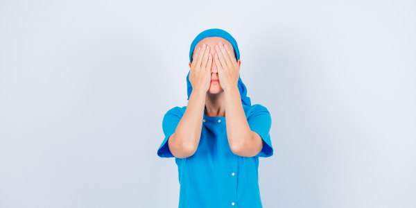 Young participant practicing intuition by closing his eyes with hands